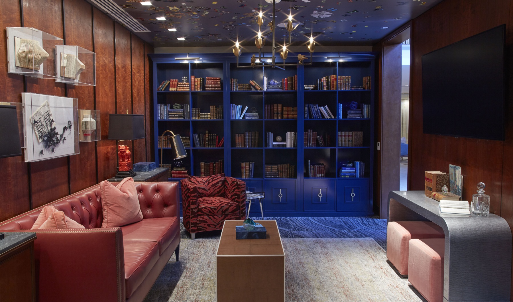 Community lounge with seating and bookcases at The National downtown Dallas apartments Community lounge with seating and bookcases at The National downtown Dallas apartments