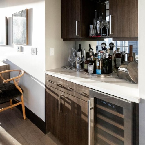 Generous living spaces to relax and unwind Wet bar in living area at The National high rise apartments in Dallas, TX
